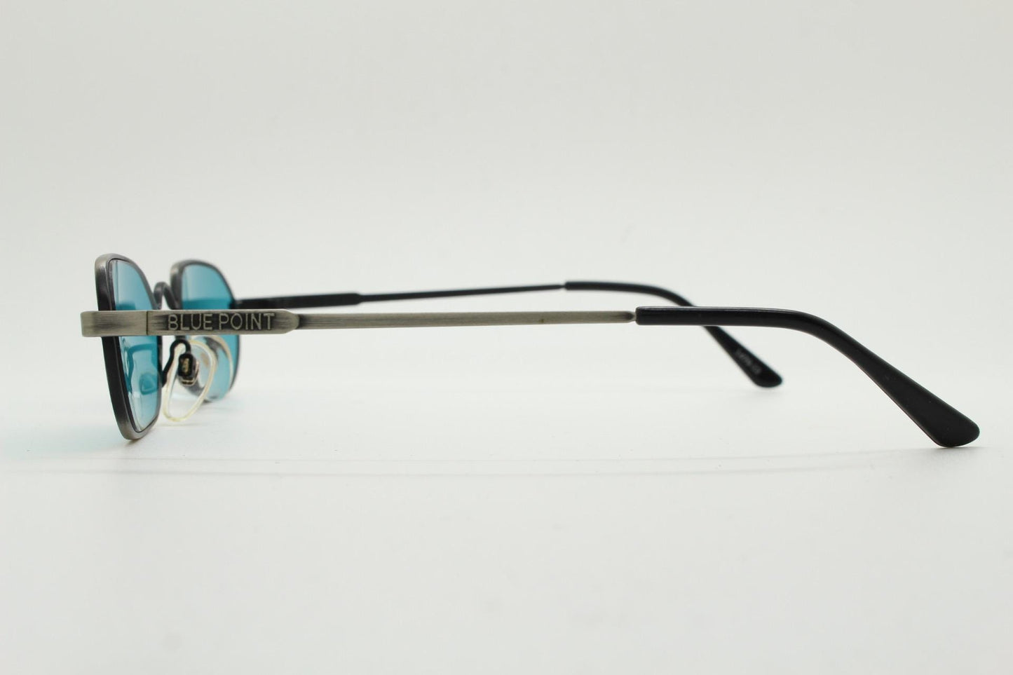 90s vintage small angular oval sunglasses by Blue Point. Low profile brushed bronze finish metal frame with turquoise blue lenses, NOS