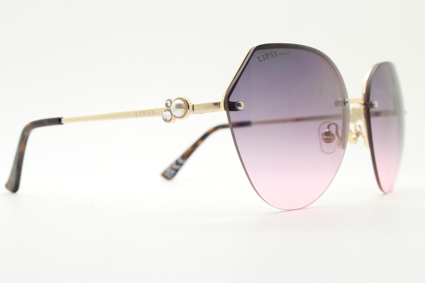 Large rimless sunglasses with dynamic angular grey to pink  graduating lenses. Women's 80s vintage style half frame with gold arms