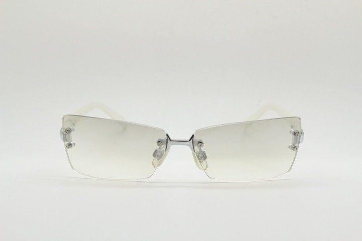 Y2K vintage  frameless sunglasses. Minimal light tone curved mirrored lenses with white frosted arms. 2000's. 90s. 00s. NOS