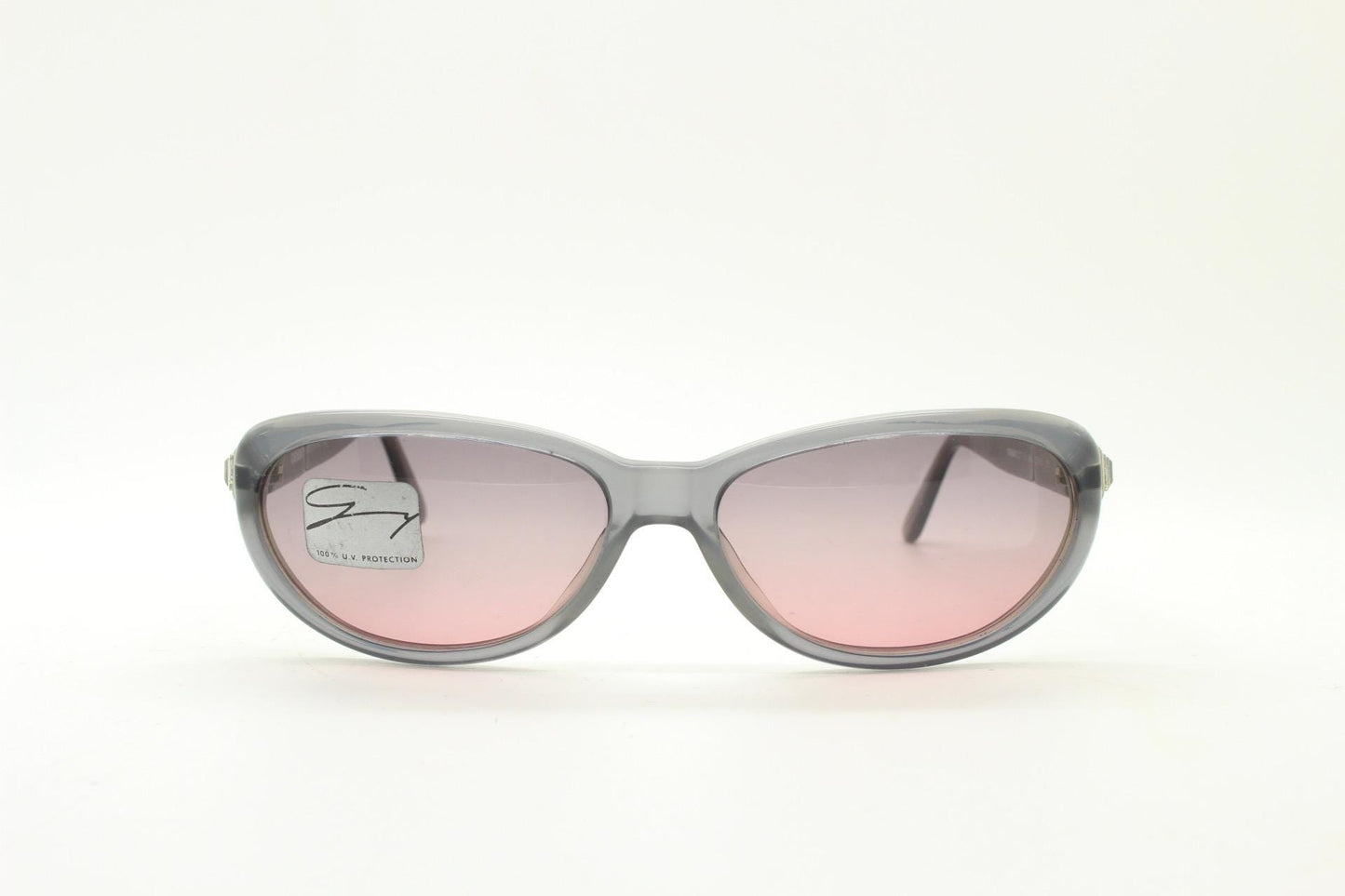 Genny 90s vintage oval cat eye sunglasses made in Italy. Transparent dark grey acetate frame with pink lenses. Womens NOS cateye. BNWT