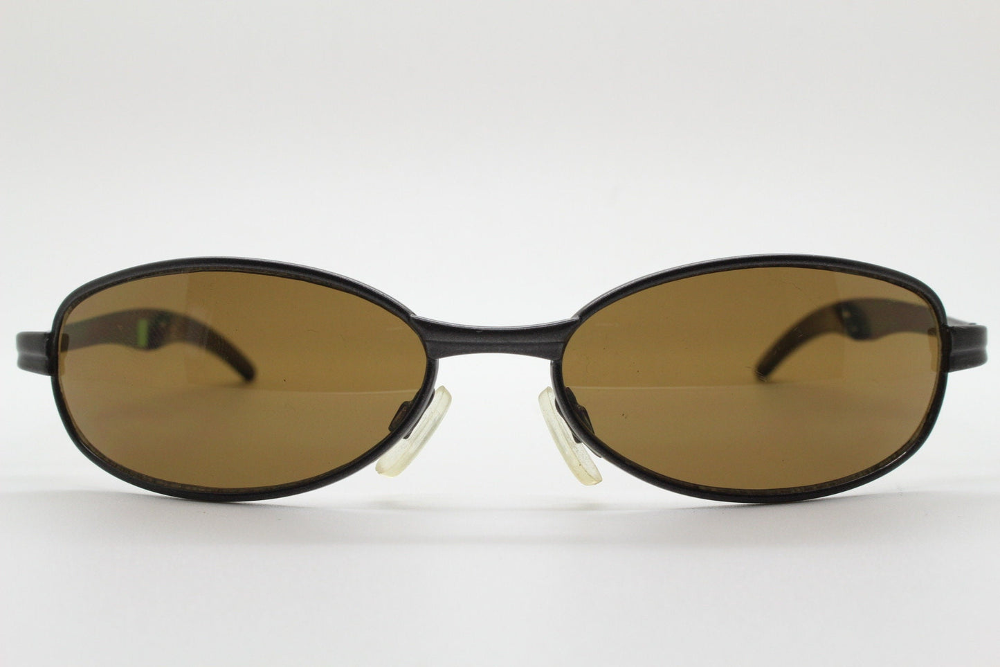 90s vintage oval small bug eye sunglasses. Curved brown satin finish solid metal frame with spear point rubber ends. Steampunk. Quality NOS