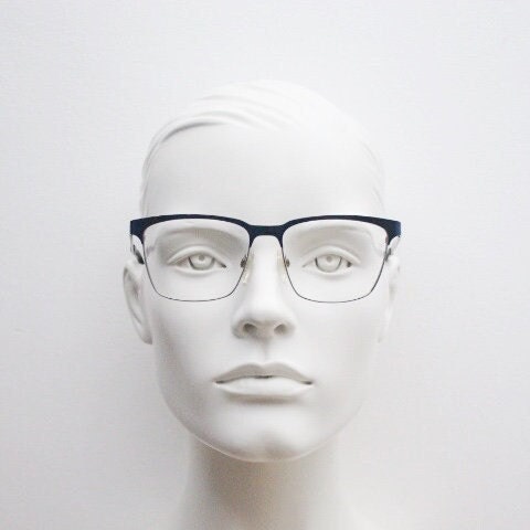 Karl Lagerfeld squared wayfarer shape eye glasses. Navy check pattern arms with satin finish brow optical frames. Prescription eyeglasses.