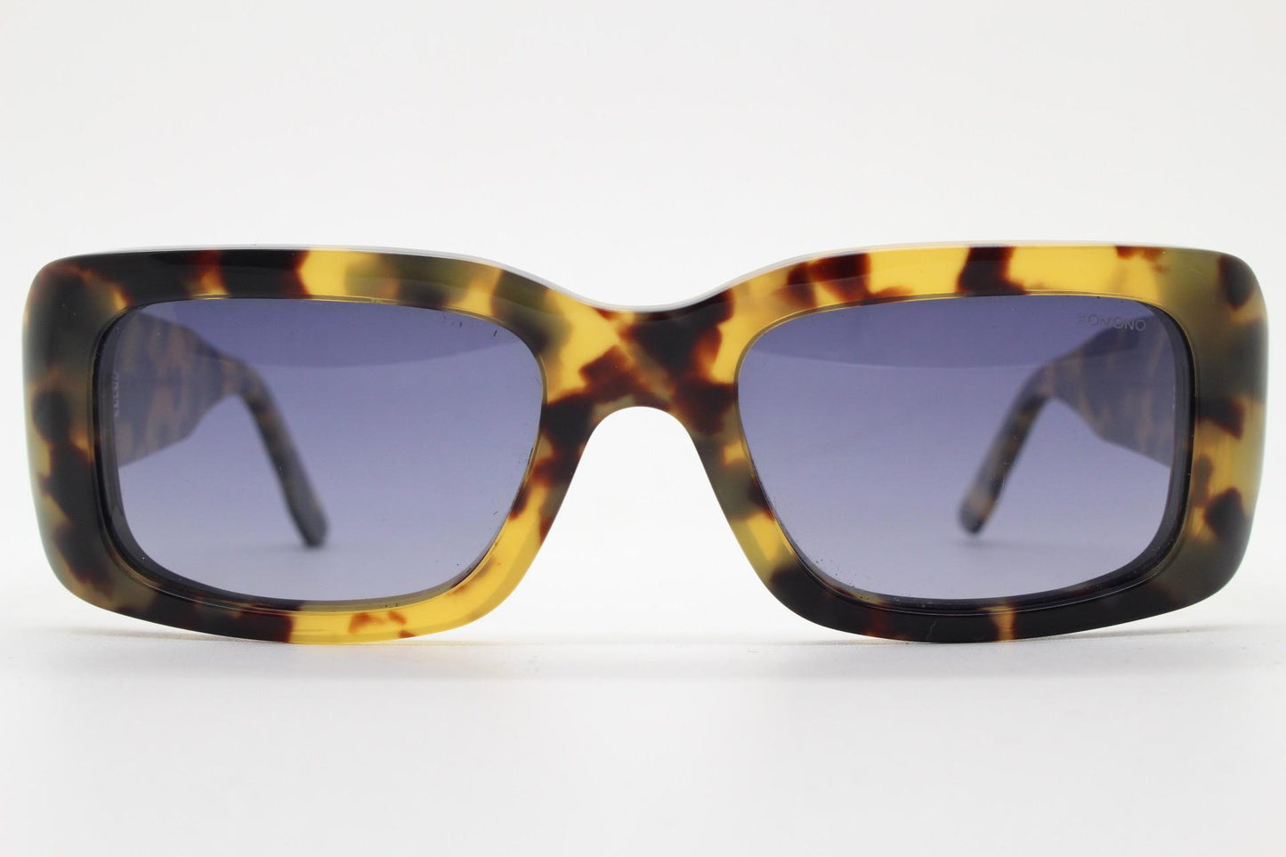 Komono chunky rectangular sunglasses model The Wes. Thick framed honey tortoise eco acetate with curved back 'goggle' sides and tall arms.