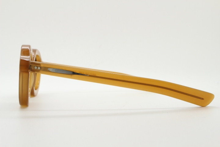 Kopajos thick framed round sunglasses. Hand made transparent amber acetate chunky frame with contrasting graduating lenses
