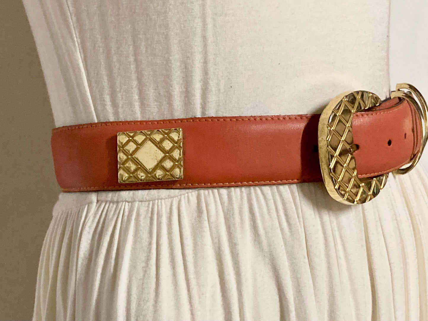 80s vintage womens dress / jeans belt in bright orange leather with golden metal squares. Made in France. Used in good condition