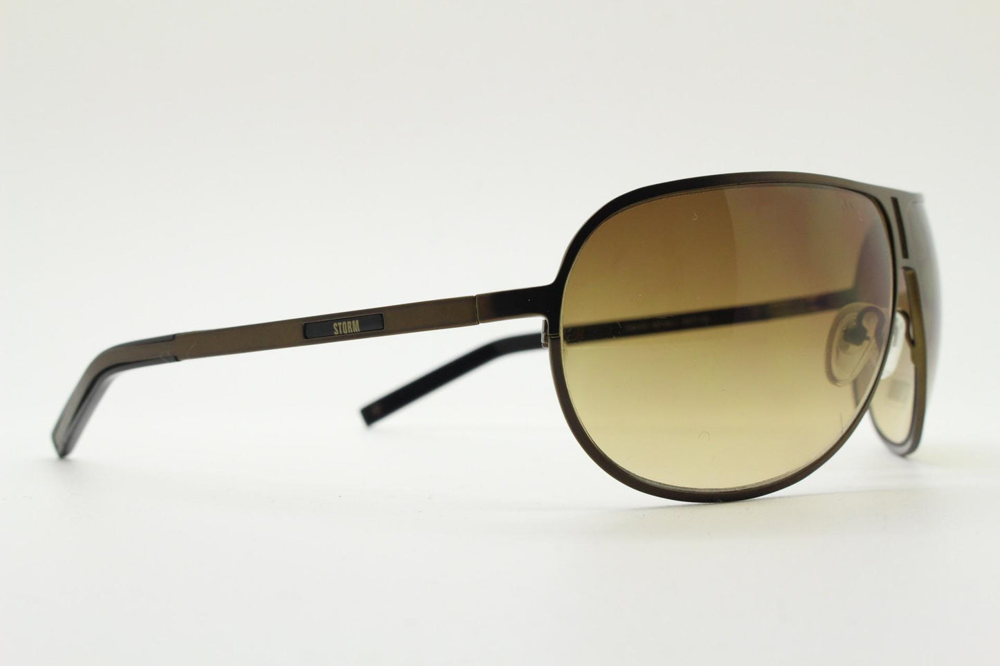 Storm Y2K bug eye aviator sunglasses model Photon. Bronze satin finish shield style aviators with graduating brown lenses.  Unused NOS.