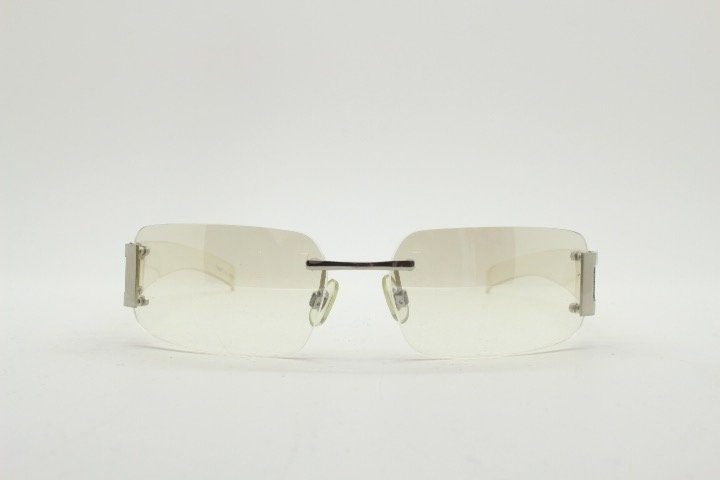 Y2K vintage wraparound sunglasses. Minimal frameless light tone curved mirrored lenses with silver chrome trim. 2000's. 90s. 00s. NOS
