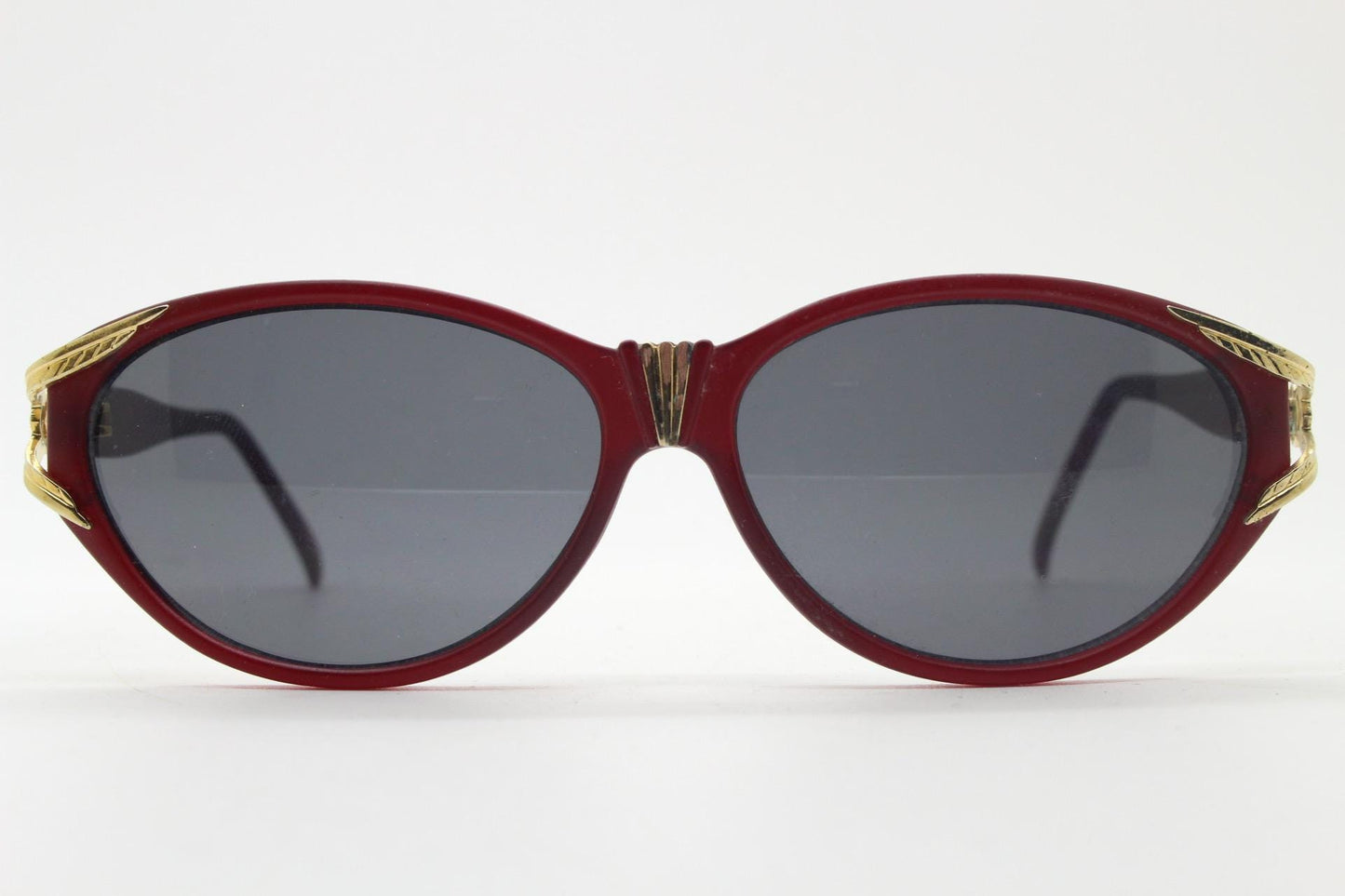 80s vintage Revlon cat eye sunglasses. Women's dark pink transparent frosted frame with golden Y fork ornate temples. 90s cateye. NOS