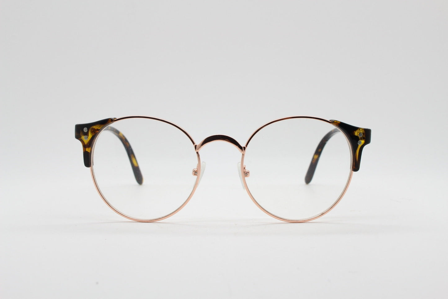 90s vintage modified cat eye glasses. Tortoise arms with a round gold face. 40s, 50s style clear lens eyeglasses. Cateye