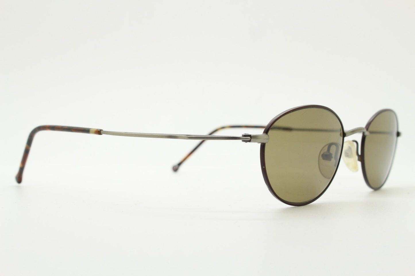 90s oval vintage metal sunglasses. Minimal satin finish bronze and brown metal frame with kinked curving arms. Steampunk. Unused NOS
