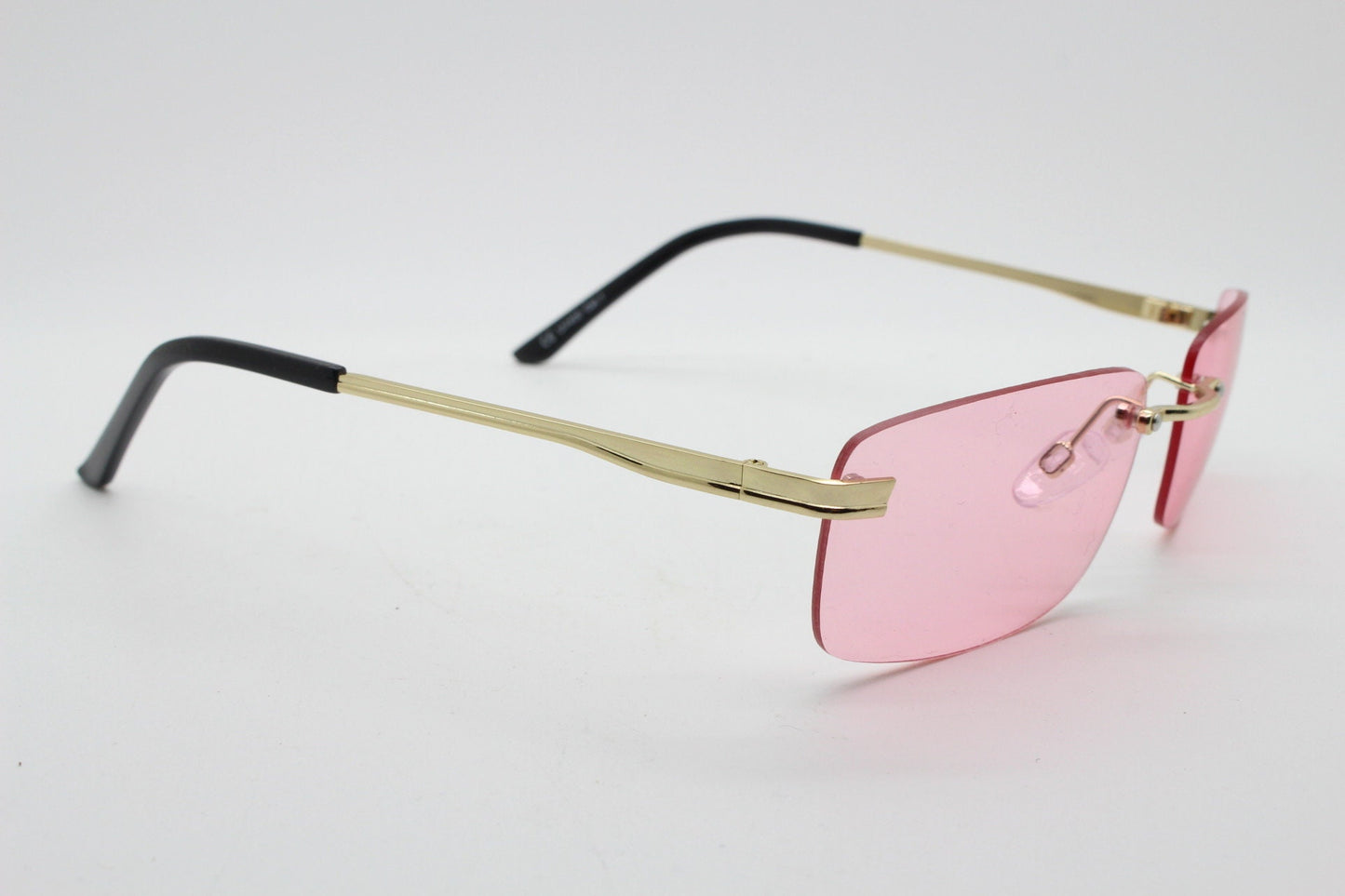 Y2K vintage frameless pink sunglasses. Rectangular lenses with gold bridge and arms. 2000s club kids. 00's. 90s Rave