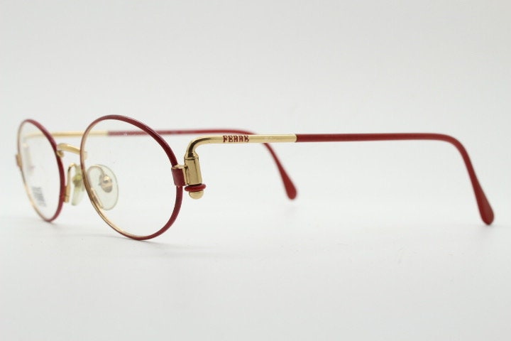 Gianfranco Ferre 90s vintage oval eye glasses made in Italy. Red and gold metal tech design optical frame. Prescription RX. NOS