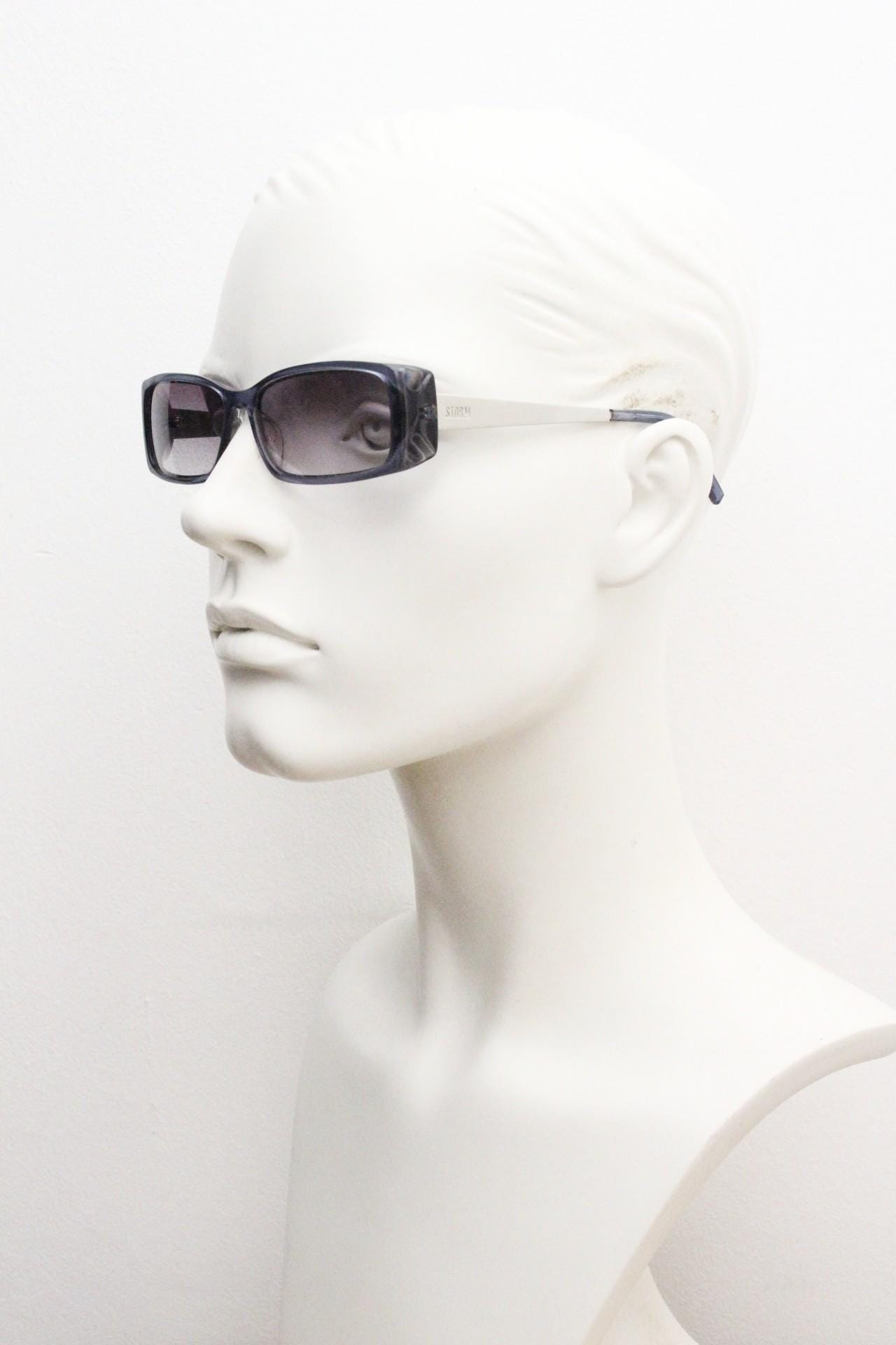 90s vintage rectangular low profile sunglasses by Storm. Transparent grey acetate front with brushed steel arms. NOS. 2000s