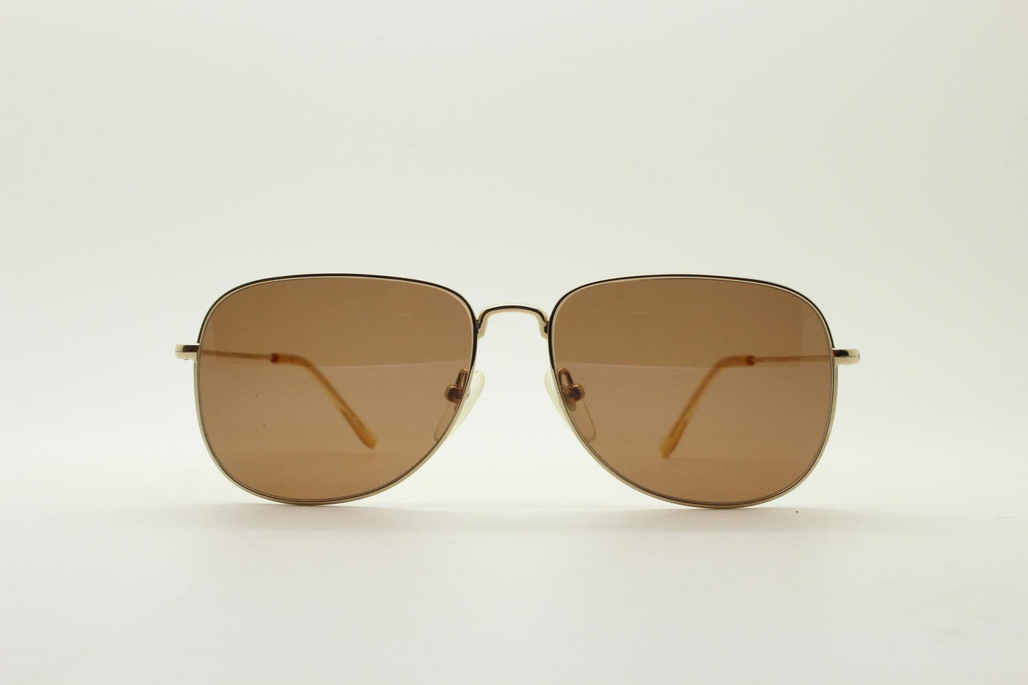 Helmut Lang rectangular 90s vintage sunglasses made in Japan. Minimal gold chrome frame with warm brown lenses. Luxury modified aviator
