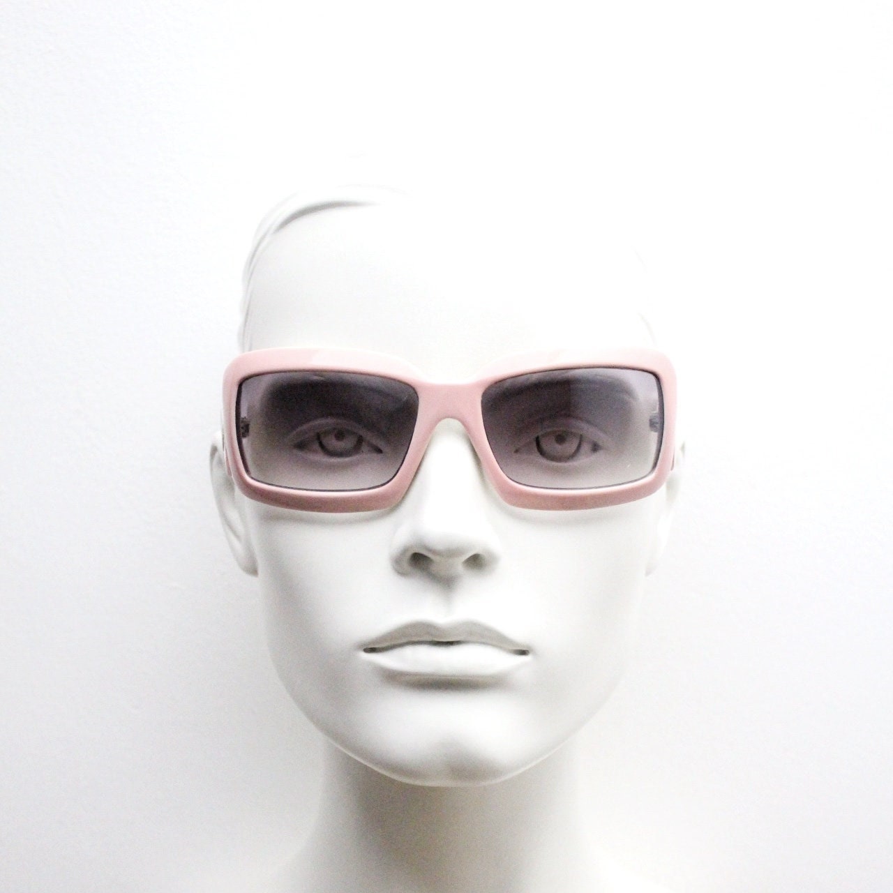 Y2k vintage rectangular wrap around bug eye sunglasses. Curving pink frame with big chain link logo. Rave shield fashion grail. 2000s NOS