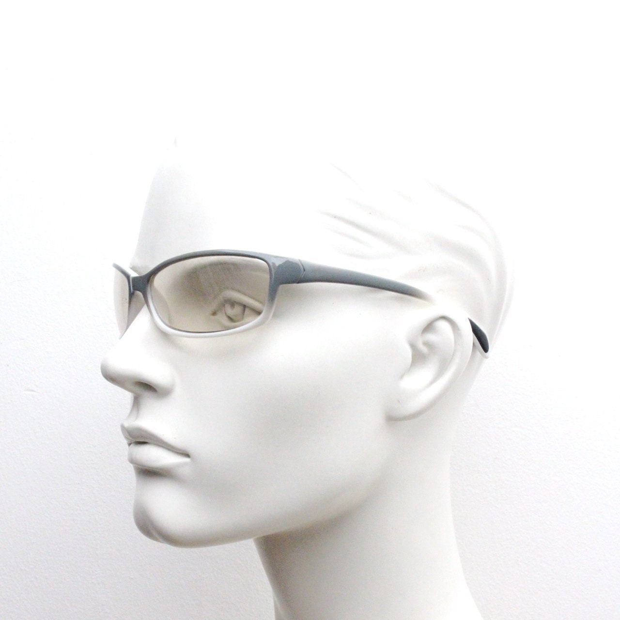 Y2K vintage futuristic sunglasses. Gloss white and grey wrap around shield style frame with light tone lenses. Cosplay visor. 2000s NOS