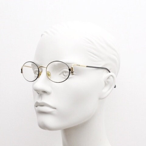 Gianfranco Ferre 90s vintage oval eye glasses made in Italy. Black and gold metal tech design optical frame. Prescription RX. NOS