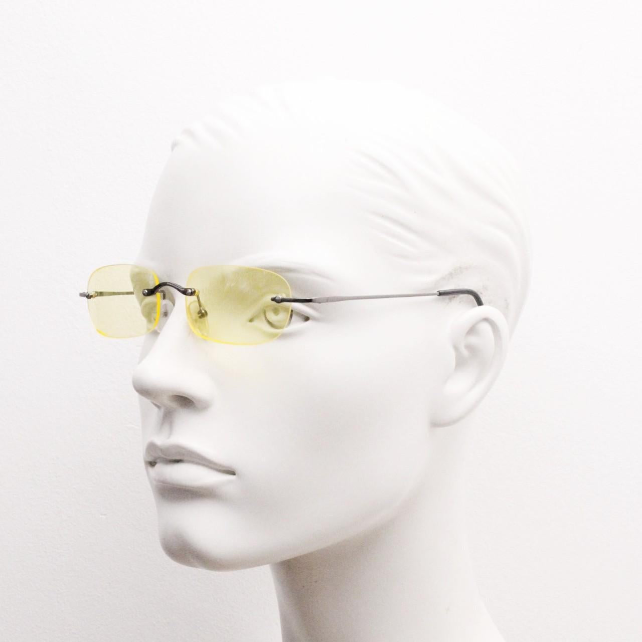 Y2K vintage frameless yellow sunglasses. Rectangular lenses with grey metal bridge and arms. 2000s club kids. 00's. 90s Rave