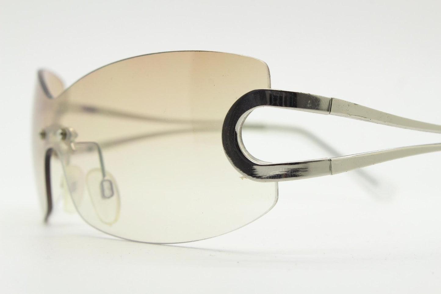 Y2K vintage visor sunglasses. 2000's brown wraparound mono lens shield design with looped chrome temples. 00s uber fashion mini mask NOS