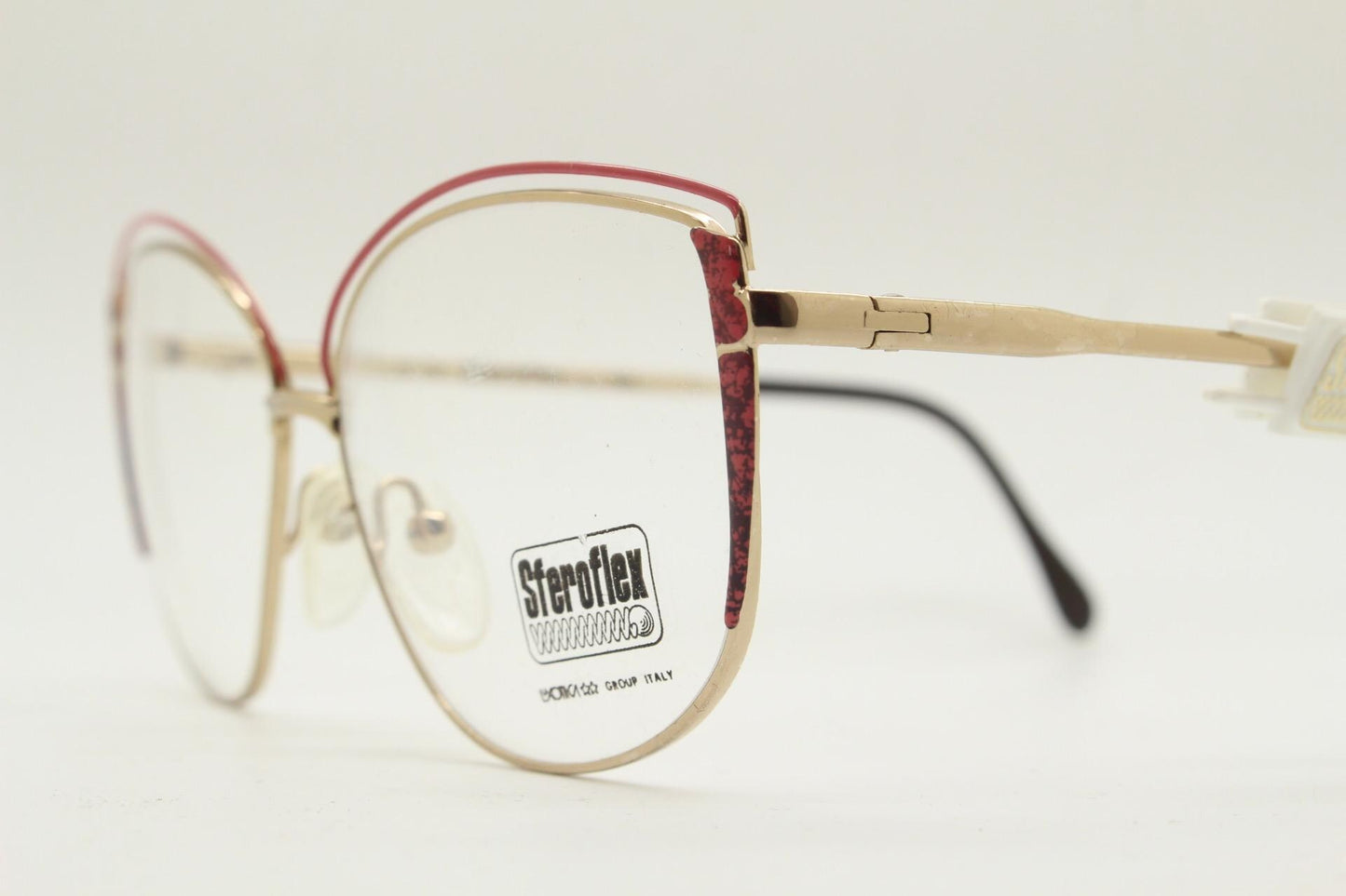Luxottica 80s vintage gold metal eye glasses made in Italy. Inventive double brow with red highlights. Optical frame. Prescription NOS