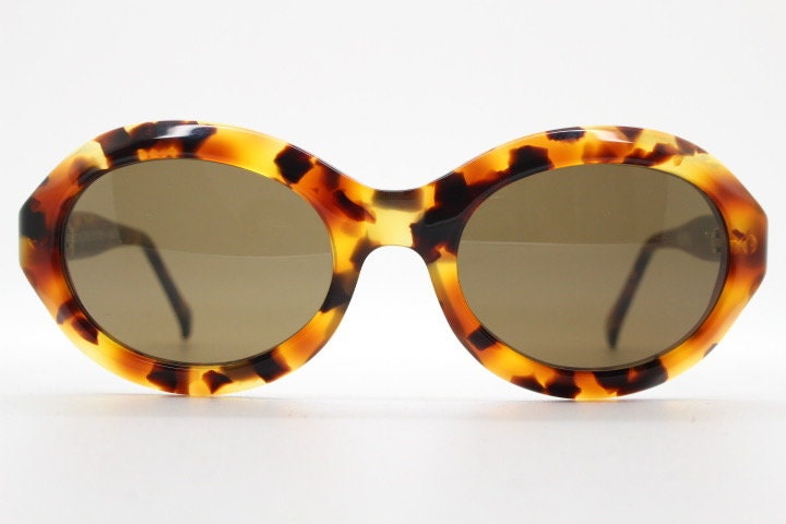 Francois Pinton Paris 90s vintage oval sunglasses made in France. Womens thick acetate frame in brown and amber tones. NOS