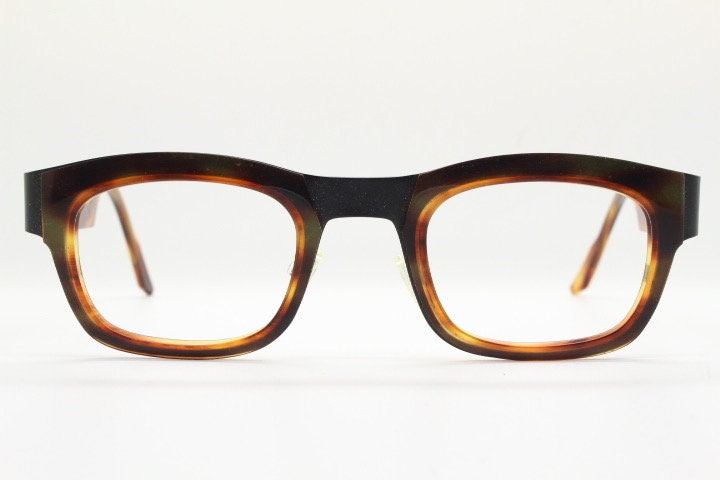 Anne et Valentin rectangular eye glasses hand made in France. Black matt titanium optical frame with mottled brown acetate. Prescription RX
