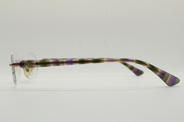 Vogue vintage frameless oval eye glasses. Transparent acetate arms with purple and green tones. Minimal Prescription RX Optical frame