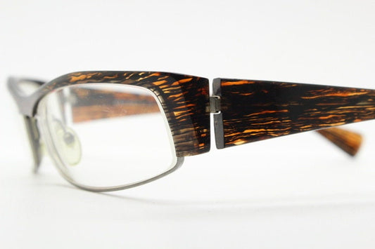 Alain Mikli 90s vintage eye glasses hand made in France. Low profile wrap around half frame in 'wood grain' acetate. Optical prescription RX
