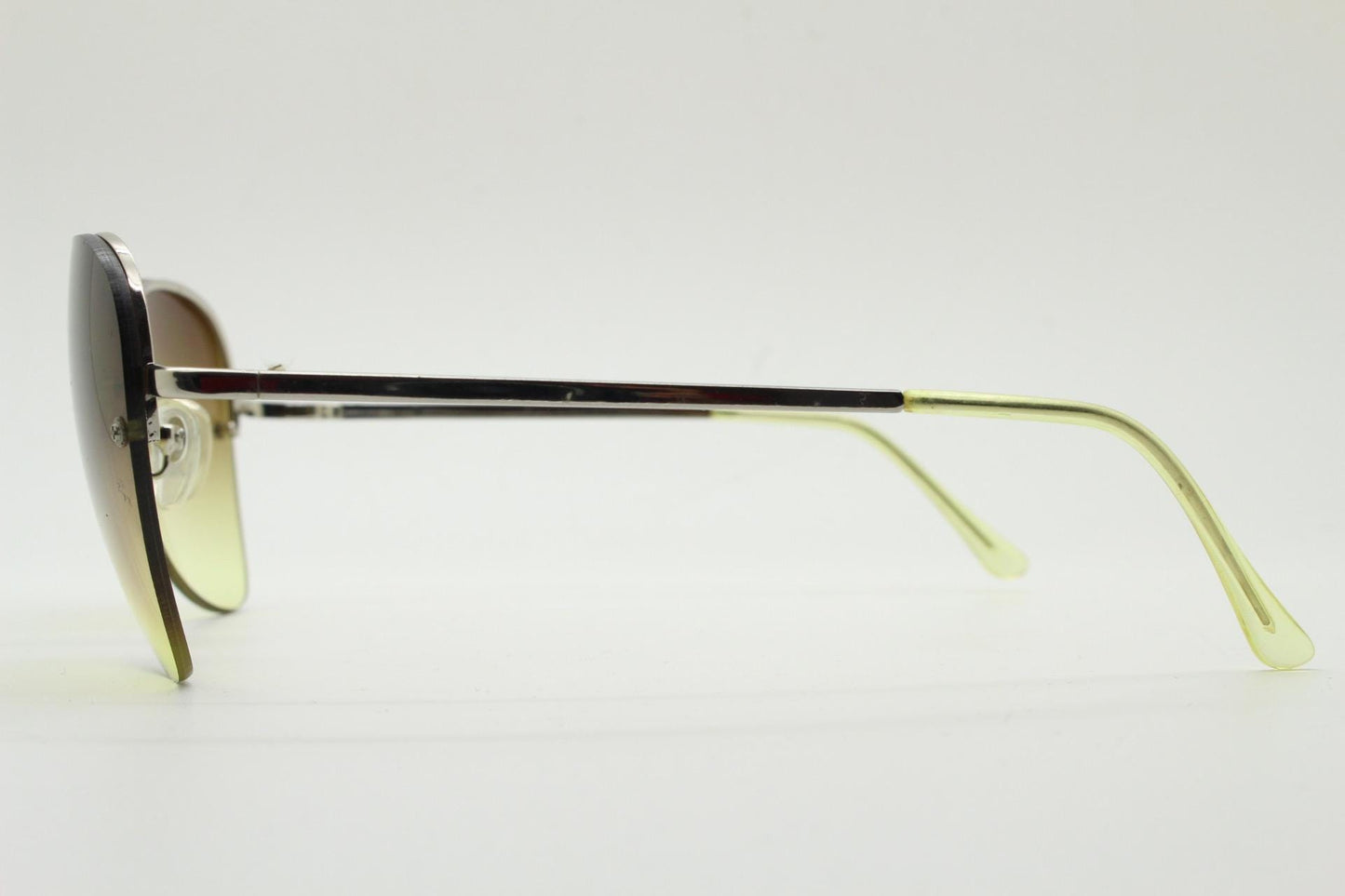 90s vintage modified teardrop aviator sunglasses. Minimal metal silver chrome half frame with compelling lenses. Teardrop aviators. NOS