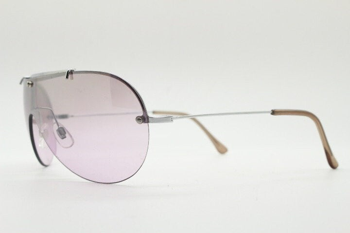 Y2K vintage visor shield sunglasses. Silver chrome half frame with pink wraparound mono lens and mirror glaze. Mini mask. 00's. 2000's NOS