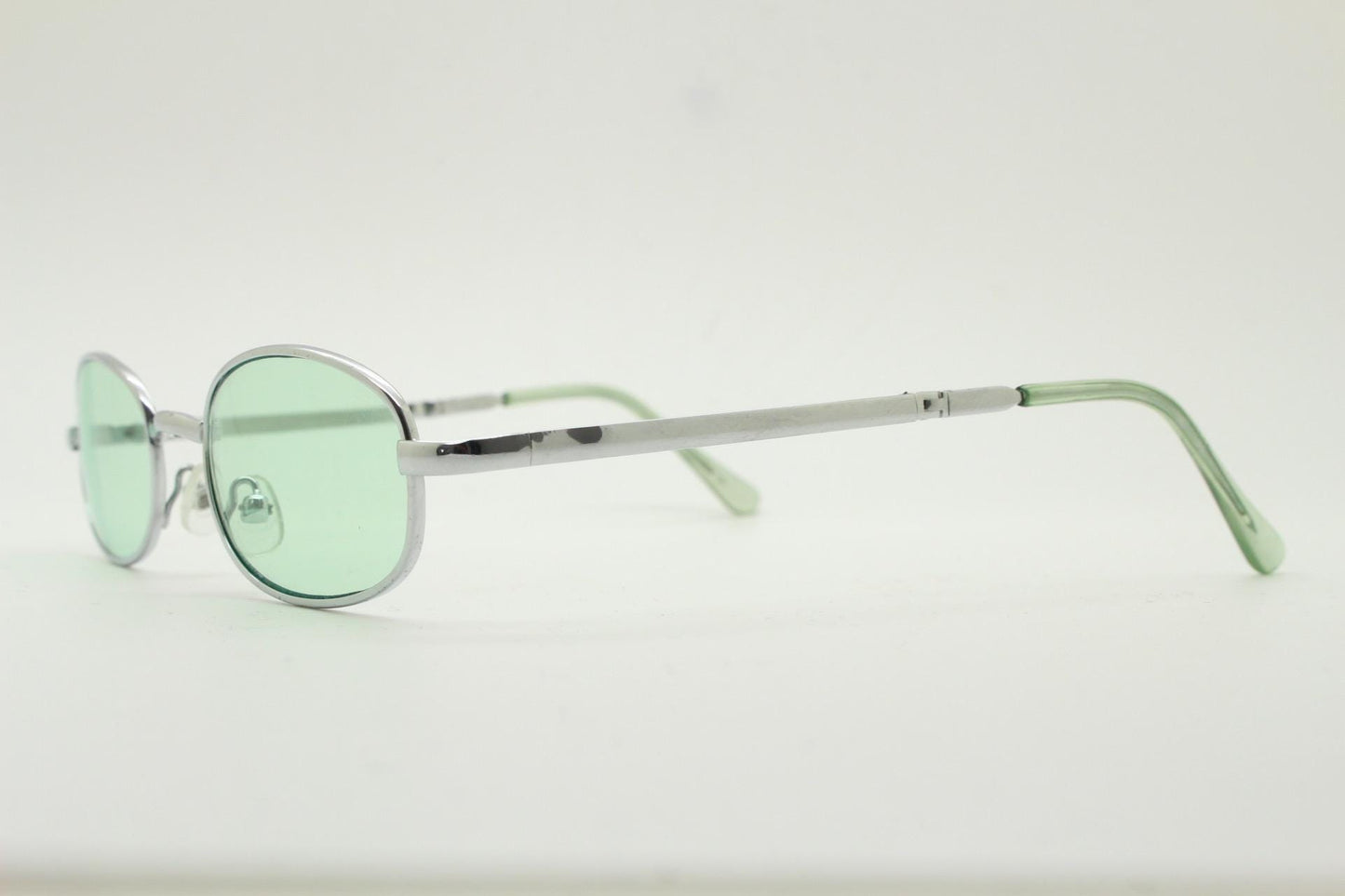 90s micro foldable oval sunglasses. Light green lenses in a small silver folding compact frame. Folder. Rave 2000s. Y2K. NOS