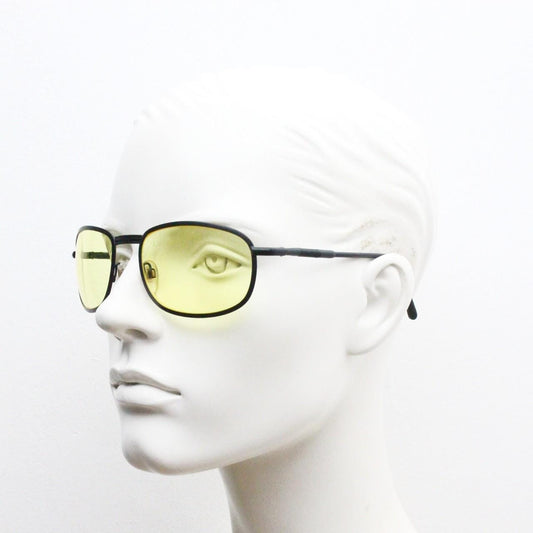 90s vintage oval bug eye sunglasses. Matt black metal frame with blazing yellow lenses and ingenious temple springs. 2000s. NOS
