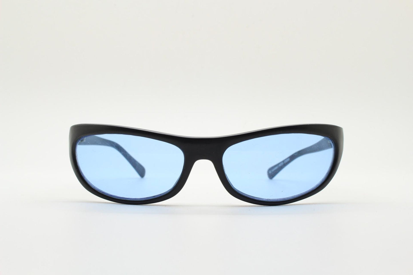 90s vintage curved wraparound sunglasses. Aerodynamic low profile black satin finish frame with light tone blue lenses. Sports shield. NOS