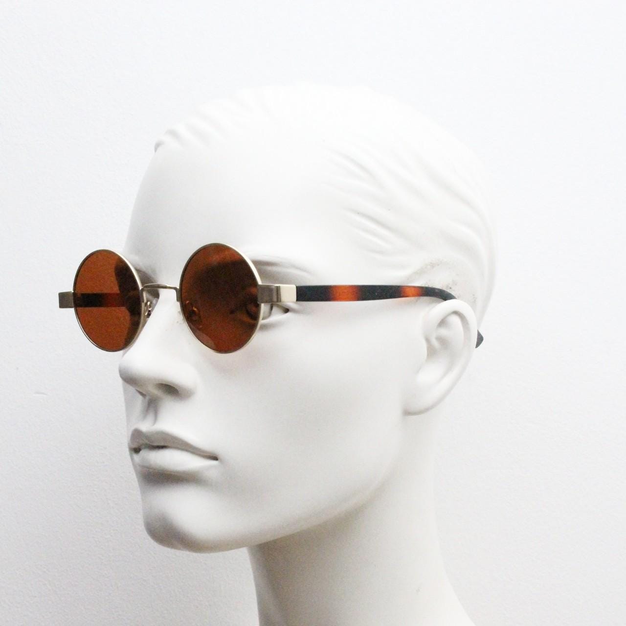 90s round vintage sunglasses. Gold 1920's style frame with tiger pattern arms and brown lenses. Unused. BNWT