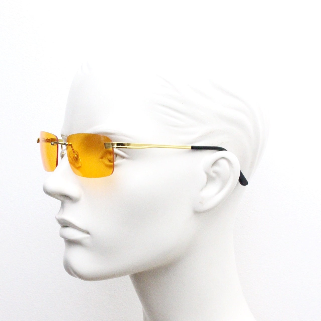 Y2K vintage frameless orange sunglasses. Rectangular lenses with gold bridge and arms. 2000s club kids. 00's. 90s Rave