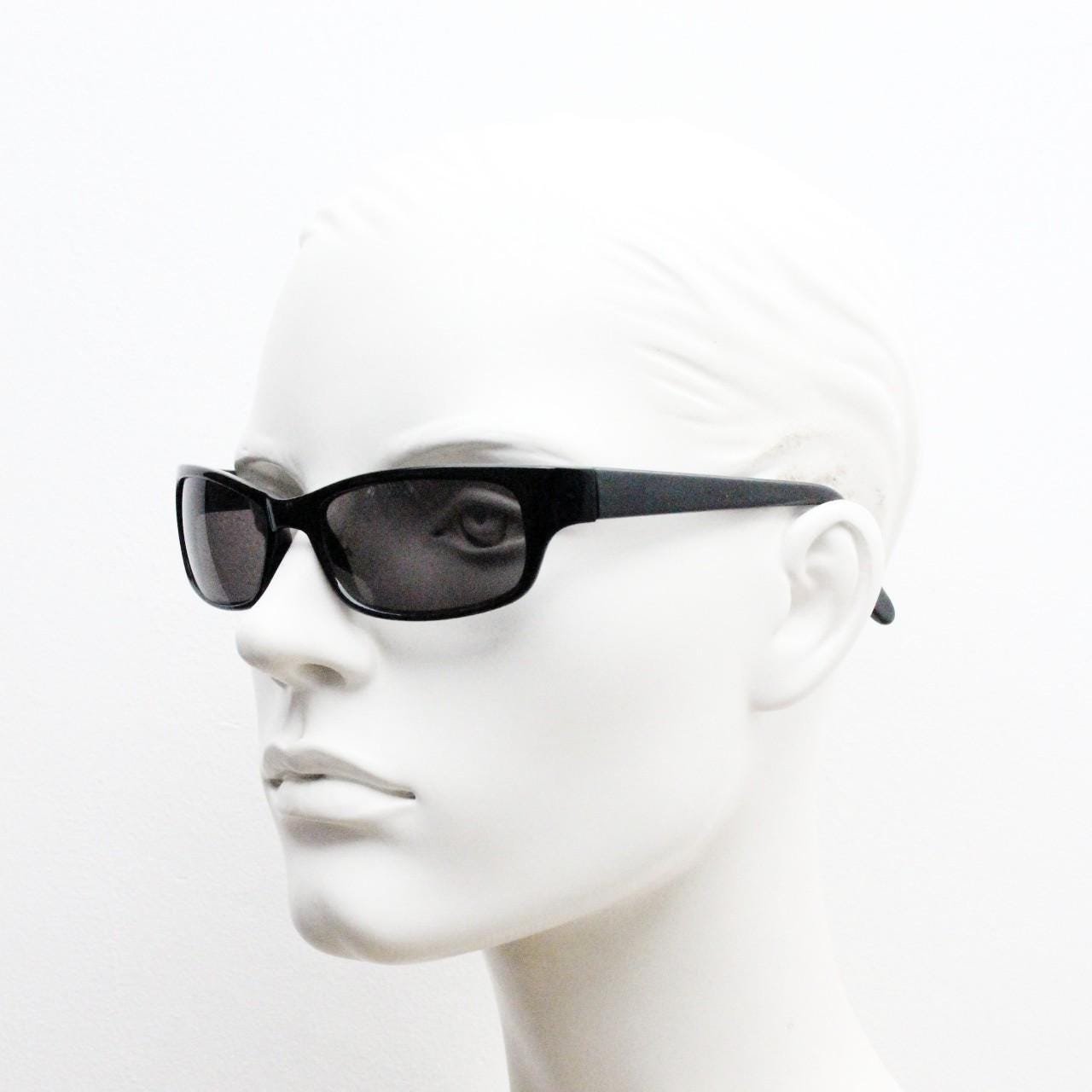 90s vintage curved wraparound sunglasses. Aerodynamic low profile plain black gloss curved cat eye frame. Minimal shield design. NOS