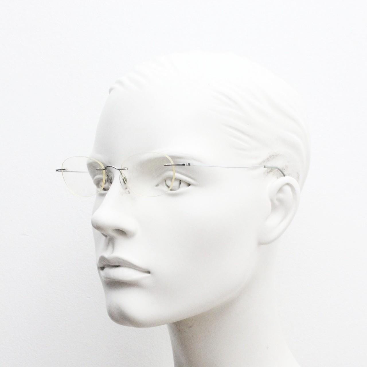Silhouette frameless oval eye glasses. Extremely minimal lightweight titanium optical frame with springy hingeless arms. 2000s Vintage