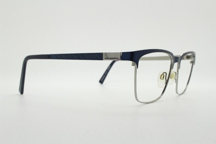 Karl Lagerfeld squared wayfarer shape eye glasses. Navy check pattern arms with satin finish brow optical frames. Prescription eyeglasses.
