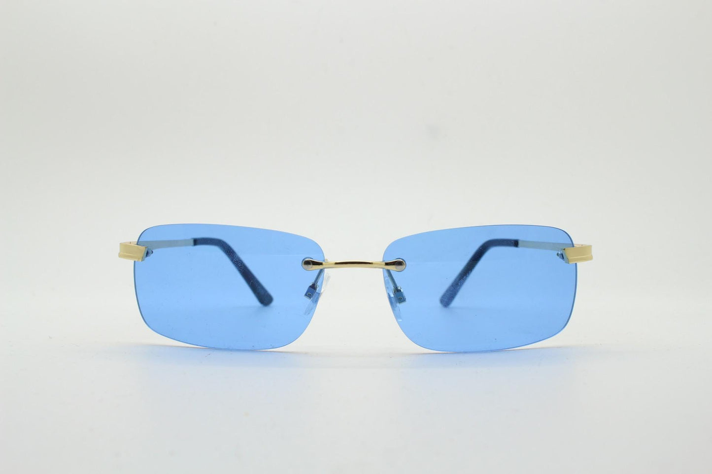 Y2K vintage frameless sky blue sunglasses. Minimalistic rectangular lenses with gold bridge and arms. 2000s club kids. 00's. 90s Rave