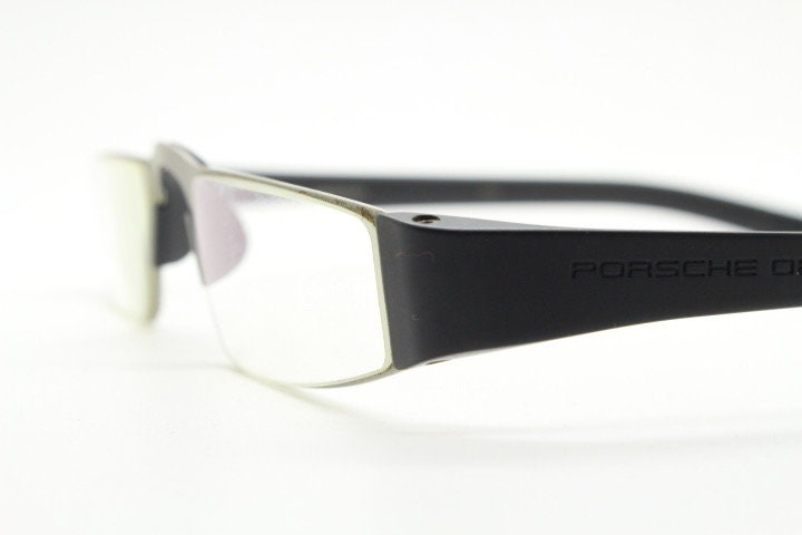 Porsche design rectangular eye glasses. Minimal grey metal optical frame in a matt finish with black arms. Vintage Prescription spectacles