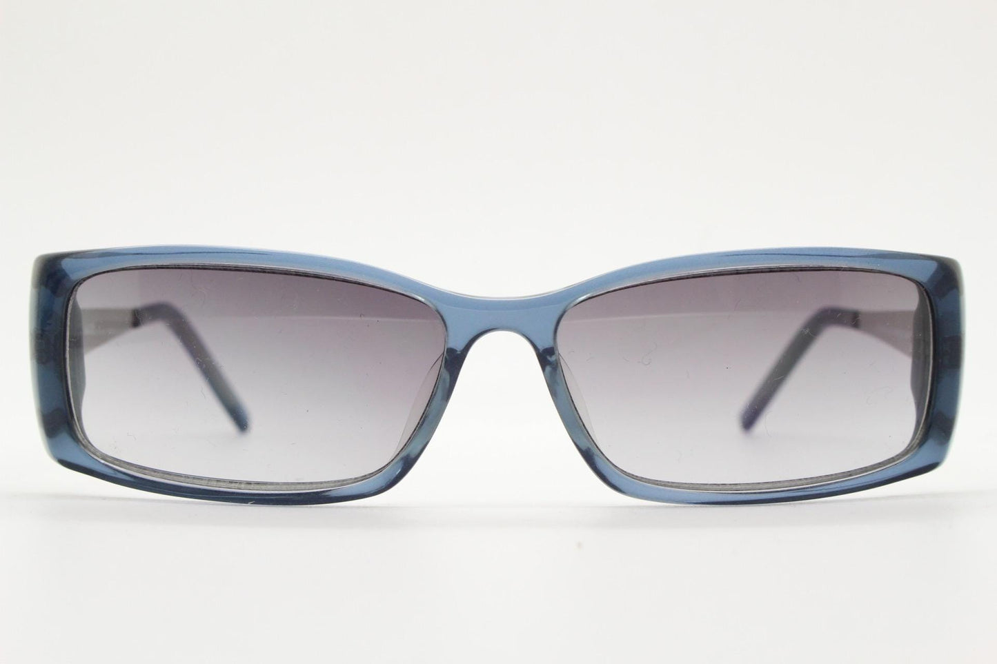 90s vintage rectangular low profile sunglasses by Storm. Transparent grey acetate front with brushed steel arms. NOS. 2000s
