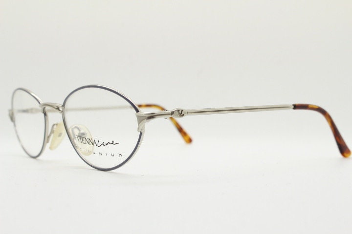 Viennaline 90s vintage oval eye glasses made in italy from titanium. Satin silver optical frame with grey enamel outline. Prescription RX