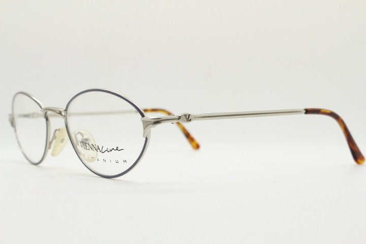 Viennaline 90s vintage oval eye glasses made in italy from titanium. Satin silver optical frame with grey enamel outline. Prescription RX