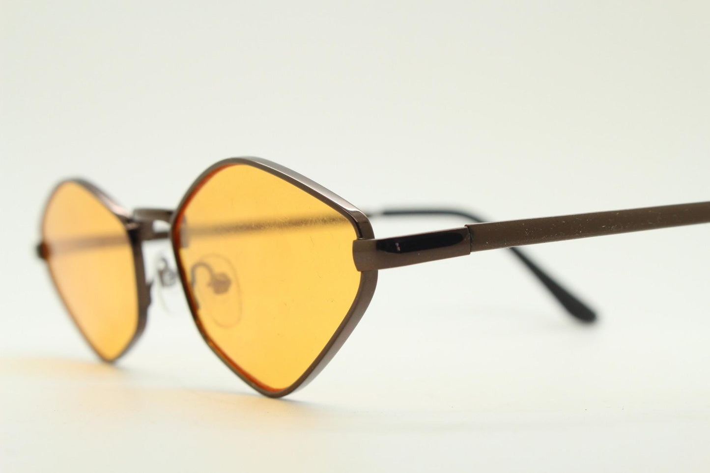 90s vintage pointed hexagon sunglasses. Minimal bronze brown psychedelic mod style frame with blazing orange lenses. Unused NOS