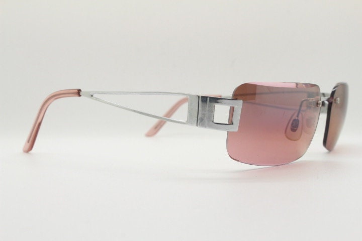 Y2K vintage rectangle frameless visor sunglasses. 2000's chrome trim wrap around with pink curved and bevelled lenses. 00's NOS