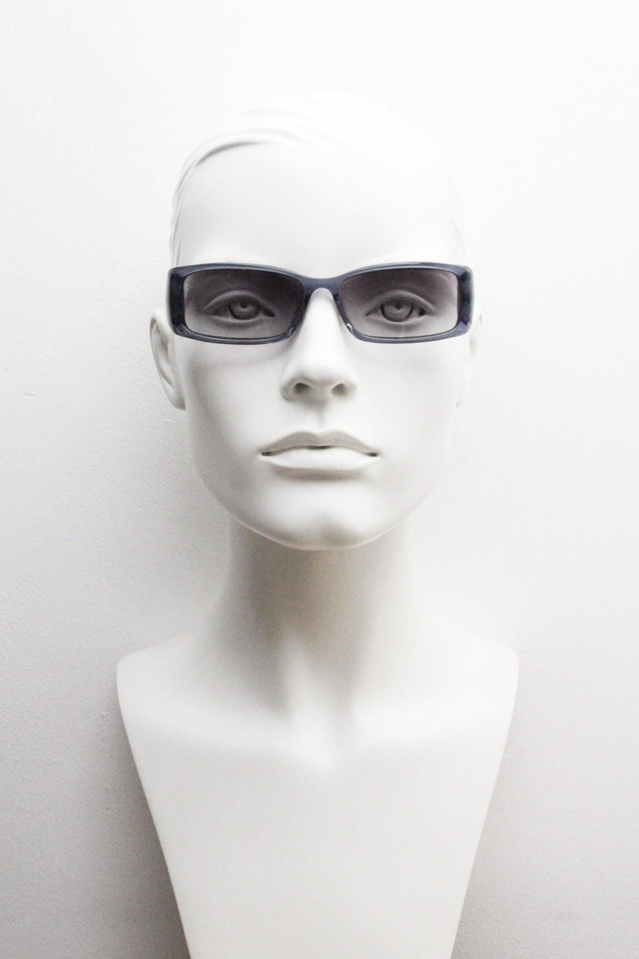 90s vintage rectangular low profile sunglasses by Storm. Transparent grey acetate front with brushed steel arms. NOS. 2000s