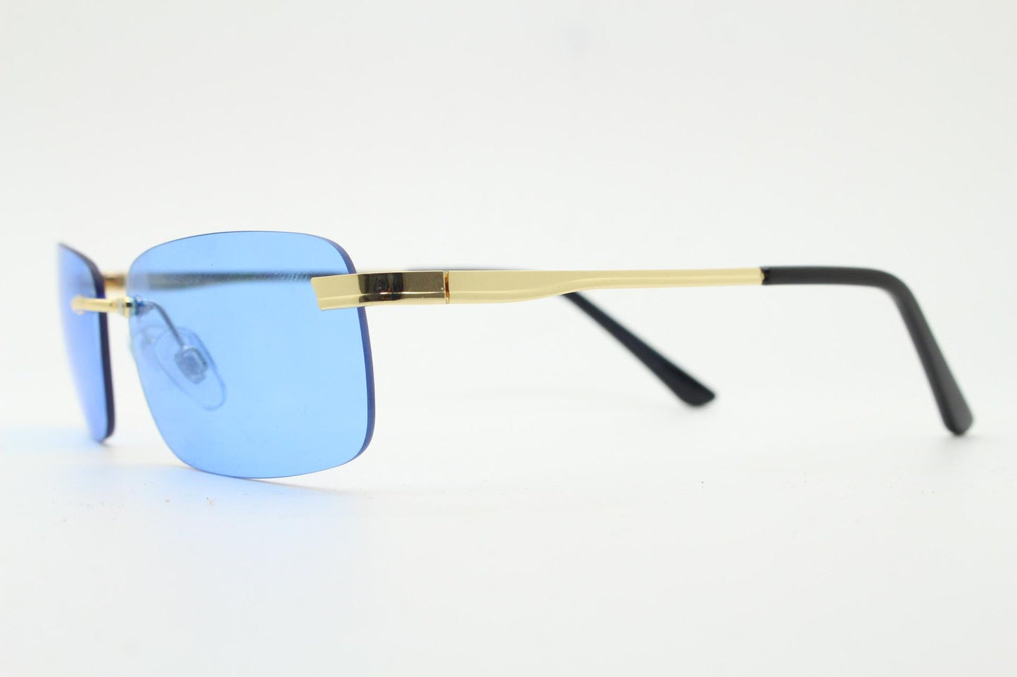 Y2K vintage frameless sky blue sunglasses. Minimalistic rectangular lenses with gold bridge and arms. 2000s club kids. 00's. 90s Rave