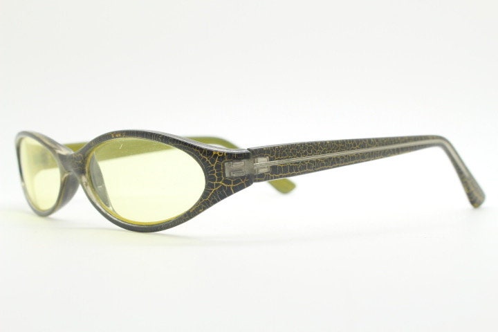 90s vintage abstract oval sunglasses. Thick curve around black frame with psychedelic yellow crackle print. Mini mask. Cosplay NOS