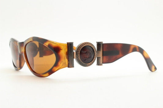 90s vintage oval sunglasses. Low profile transparent tortoise frame with massive bronze metal arm crests BNWT. Unused NOS