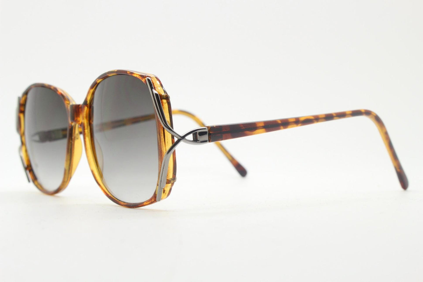 80s vintage square sunglasses. Womens honey tortoise frame with dynamic metal  forked side joints and graduating lenses. 70s. Unused NOS